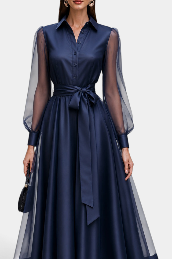 Mahaute navy blue satin-effect midi shirt dress with sheer long sleeves, buttoned bodice, and a tied waist belt.