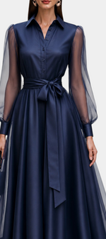 Mahaute navy blue satin-effect midi shirt dress with sheer long sleeves, buttoned bodice, and a tied waist belt.