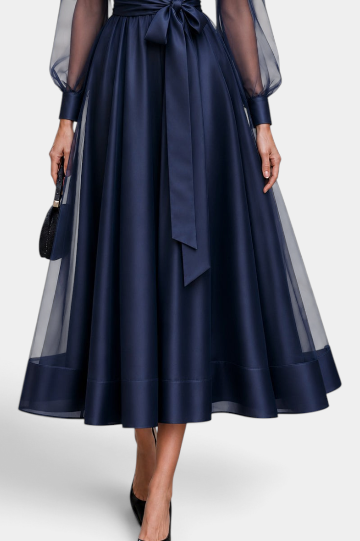 Mahaute Eirene midi dress in navy satin with sheer sleeves, a tied waist, and a flared skirt for formal events.
