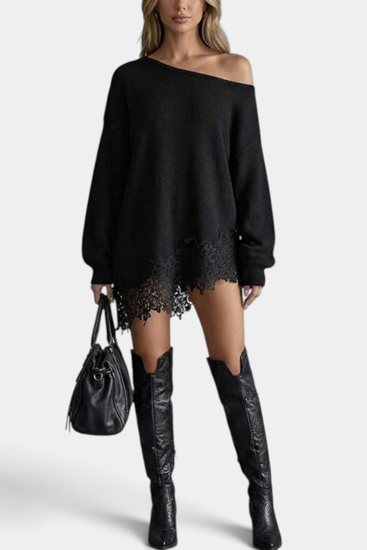 Mahaute black oversized knit sweater dress with off-the-shoulder neckline and floral lace hem, worn with tall boots.