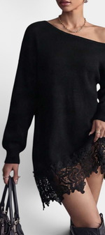 Mahaute Mishel black oversized knit sweater dress with an off-shoulder neckline and floral lace hem detail.