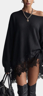 Mahaute black oversized knit sweater dress with an off-shoulder neckline and delicate floral lace hem detail.