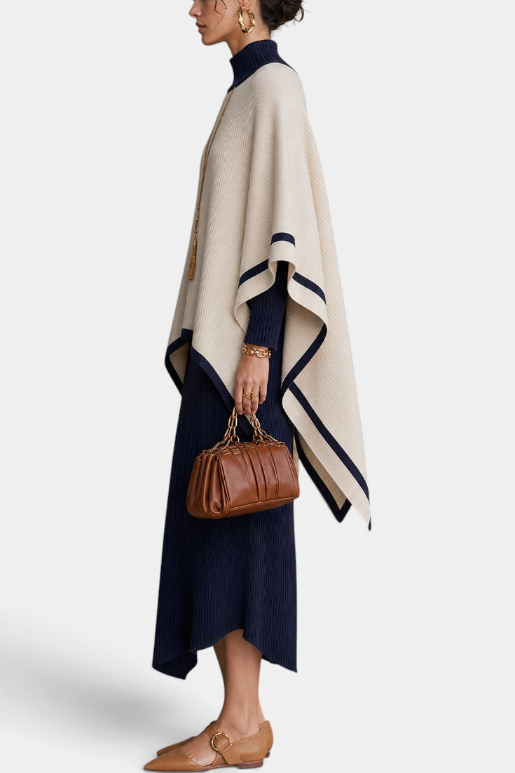 Mahaute ensemble featuring a navy ribbed turtleneck maxi dress and a cream poncho with navy contrast trim