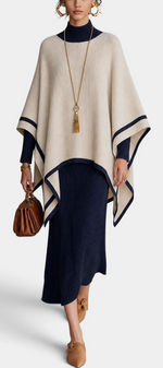 Mahaute ribbed knit long dress and contrasting poncho set in navy and cream worn by a model with gold accessories.