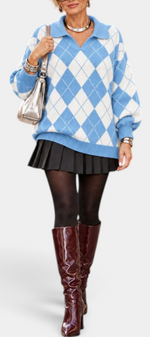 Mahaute Zafloria blue and white argyle knit polo sweater with puff sleeves worn with a black pleated skirt and boots