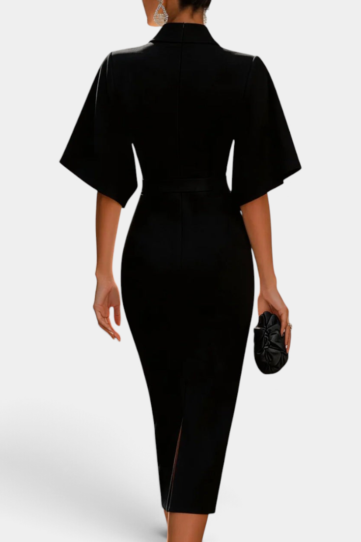 Back view of a woman wearing a Mahaute black midi dress with flared sleeves, cinched waist, and a back slit.