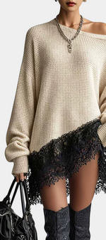 Mahaute beige oversized knit sweater dress with an off-shoulder neckline and black floral lace hem detail.