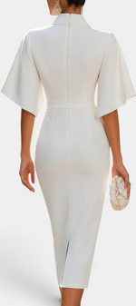 Mahaute Radoslava white midi dress with flared sleeves, cinched waist, and back slit, viewed from behind.
