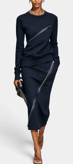 Ensemble Mahaute Vildana avec haut à manches longues et jupe mi-longue à zips asymétriques, tissu noir élégant.