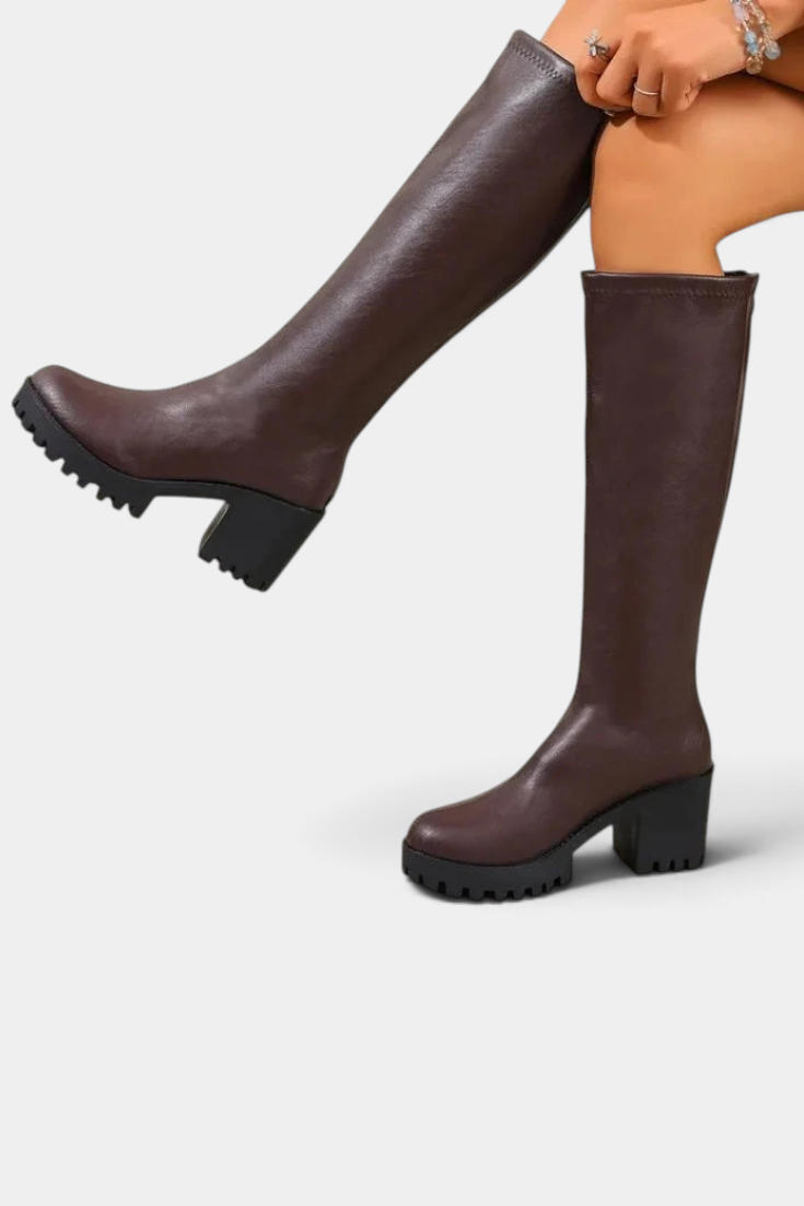 Mahaute Suny brown knee-high boots with a chunky block heel and thick lug sole for a modern urban look.