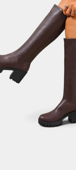 Mahaute Suny brown knee-high boots with a chunky block heel and thick lug sole for a modern urban look.