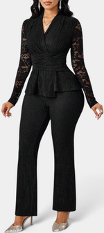 Mahaute black two-piece set with a peplum top, long floral lace sleeves, and matching tailored trousers.