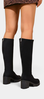 Mahaute Suny black knee-high boots with a chunky block heel and lug sole, viewed from the back.