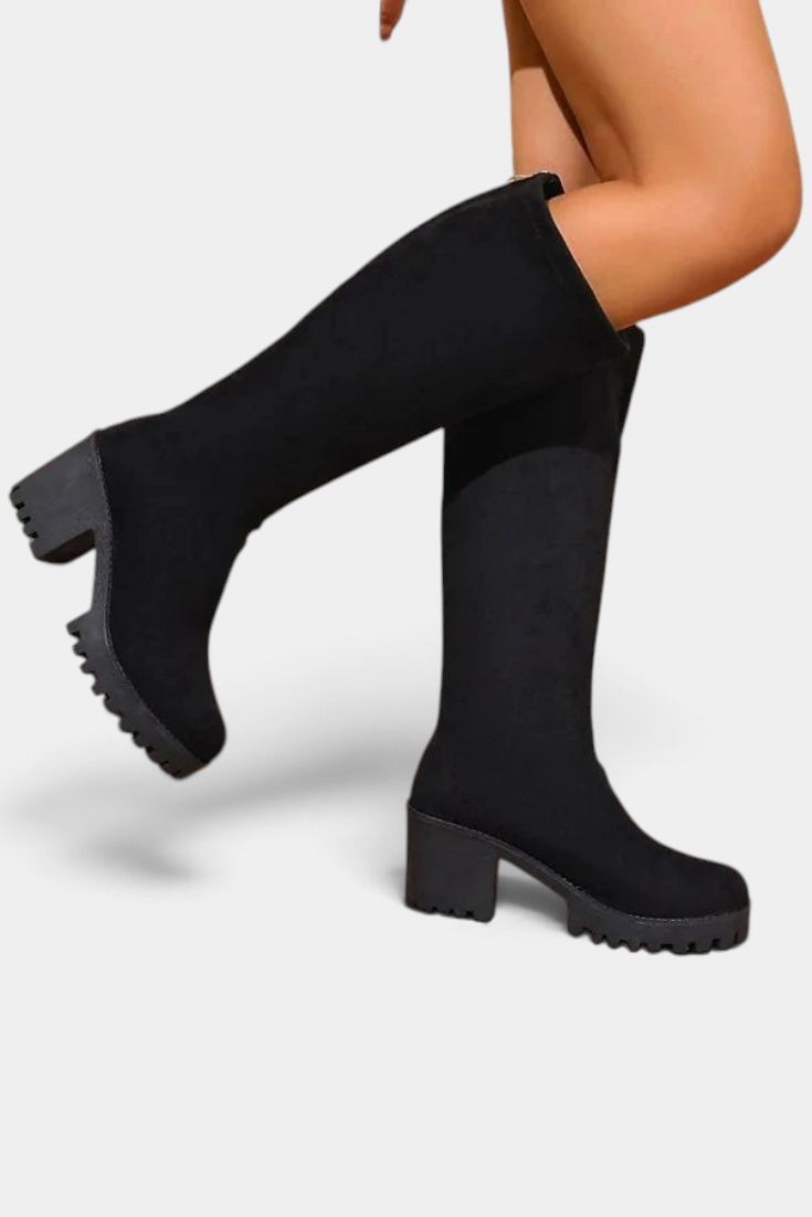 Mahaute Suny black knee-high boots with a chunky block heel and thick lug sole for a modern urban look.