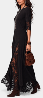 Mahaute Meliorine black maxi dress with floral lace inserts, mid-length lace sleeves, and a flowing silhouette.