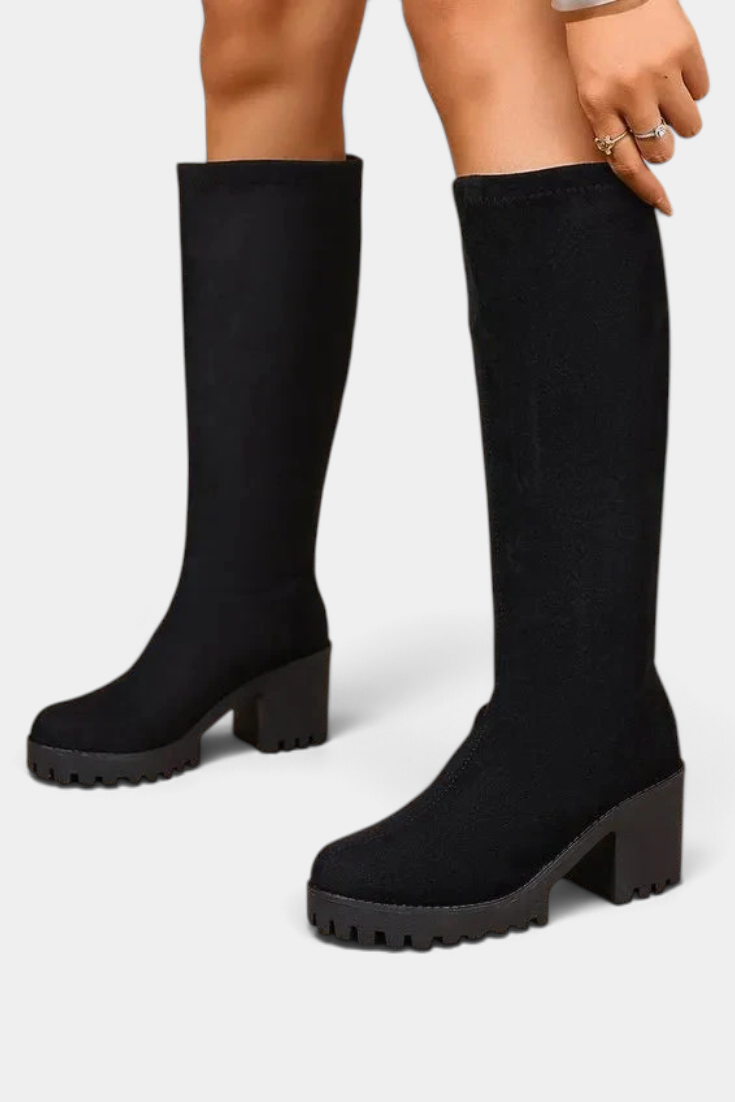 Mahaute Suny black knee-high boots with a chunky block heel and thick lug sole for a modern urban look.