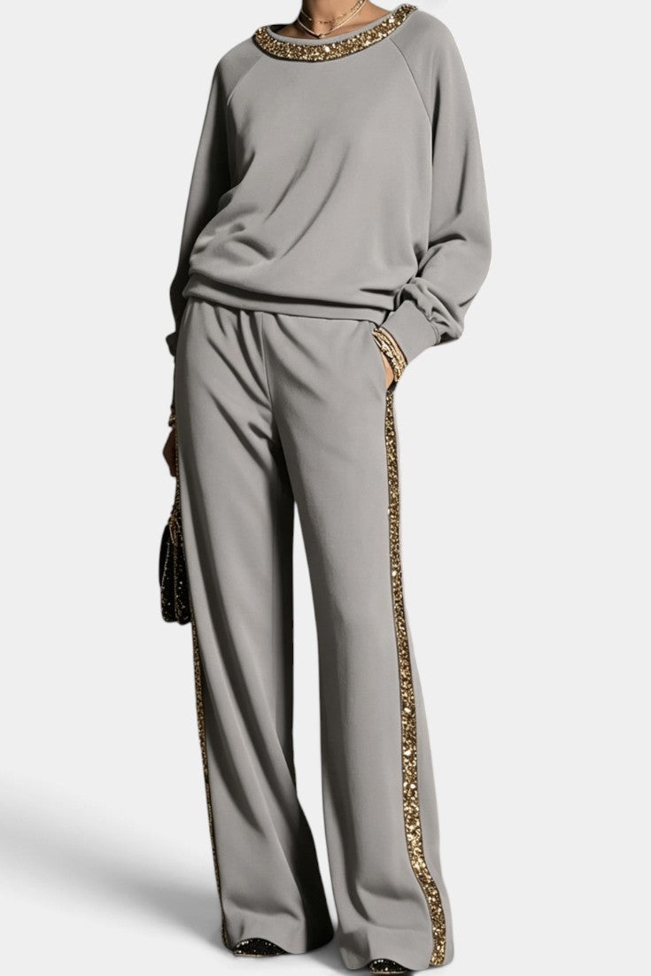 Ensemble Mahaute Valésia avec pantalon large à finitions dorées et col orné, élégance et style contemporain.