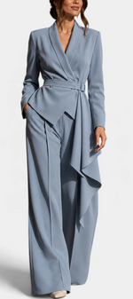 Mahaute Adalina dusty blue belted blazer and wide-leg trouser set with an elegant asymmetrical draped side panel.