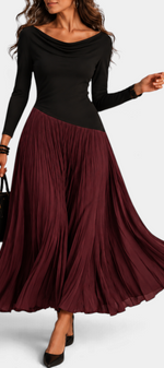 Mahaute Adelajda long black and burgundy pleated dress with draped neckline and asymmetrical waist on a model