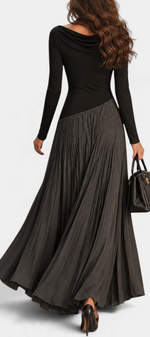 Mahaute Adelajda long black pleated dress with draped neckline and asymmetrical waist, back view on a model.