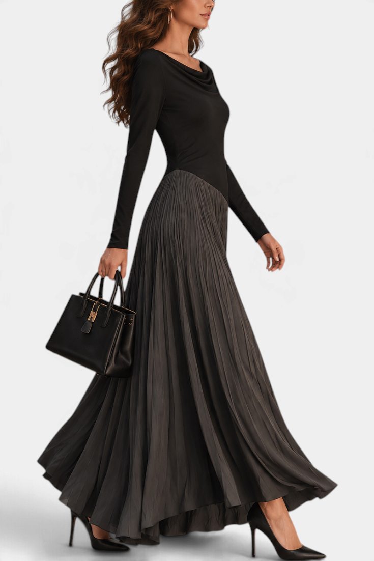 Mahaute Adelajda long black dress with draped neckline, long sleeves, and an asymmetrical pleated skirt in motion.