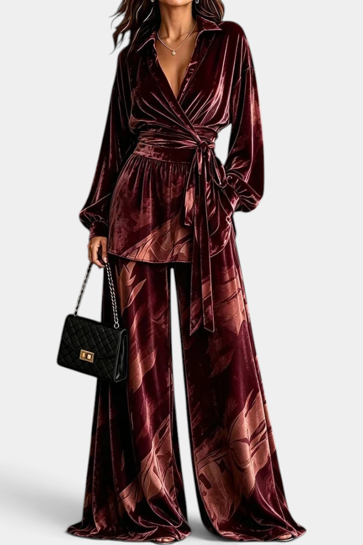 Mahaute Adeline burgundy velvet wrap blouse with belted waist and matching wide-leg botanical print trousers.