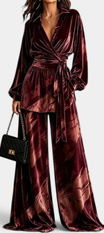 Mahaute Adeline burgundy velvet wrap blouse with belted waist and matching wide-leg botanical print trousers.