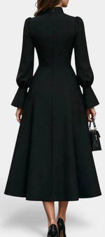 Back view of Mahaute Albena black midi dress featuring a high gathered collar, puff sleeves, and a flared skirt.