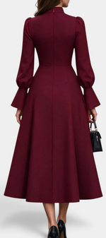 Back view of Mahaute Albena midi dress in burgundy with high ruffled collar, puffed sleeves, and flared skirt.