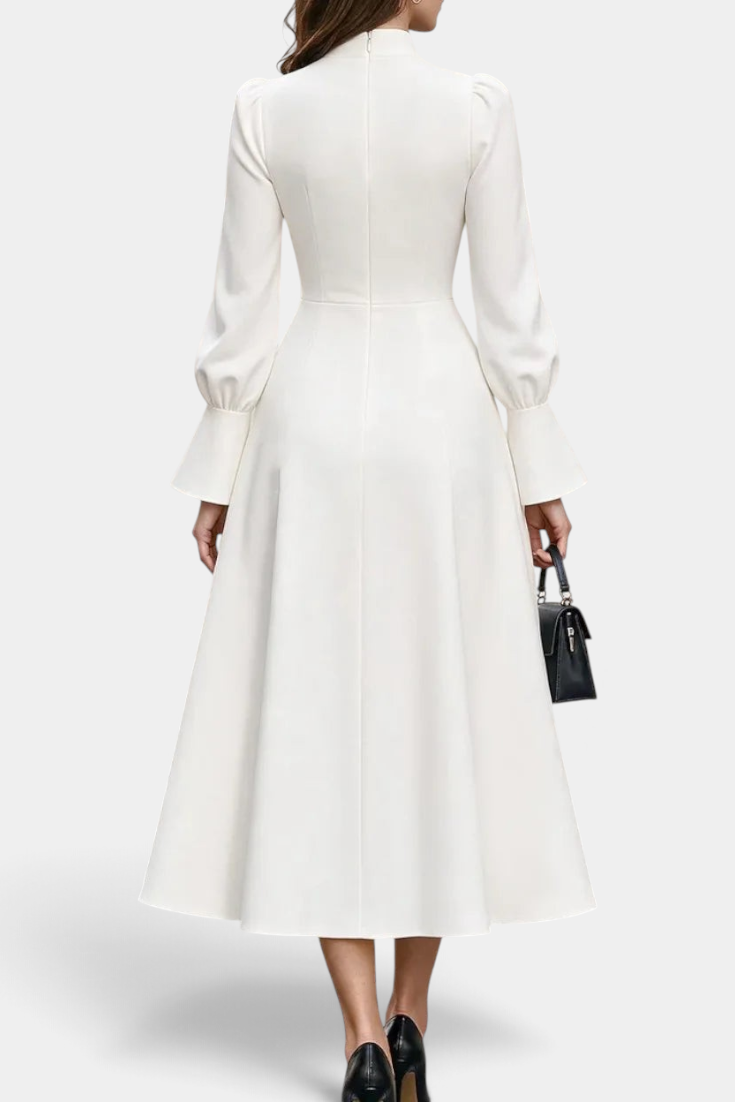 Back view of Mahaute Albena midi dress in white with puffed sleeves, flared skirt, and high gathered neckline.