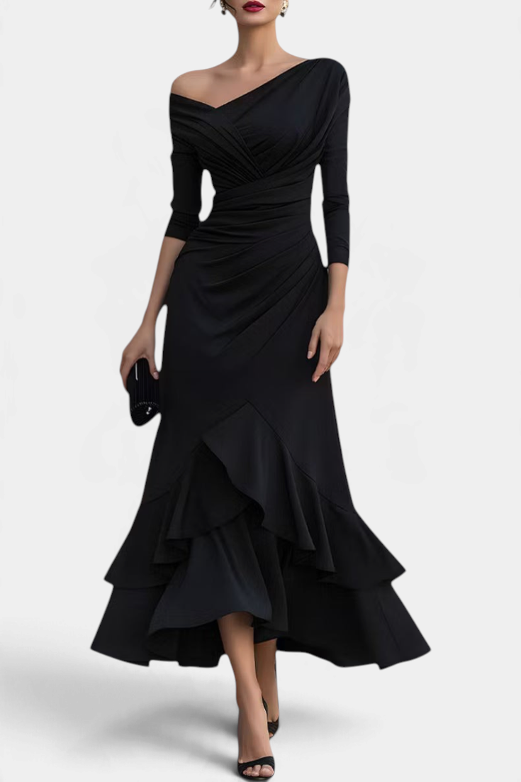 Mahaute black long evening dress with asymmetrical off-shoulder neckline, draped bodice, and layered ruffled hem.
