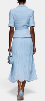 Back view of Mahaute Amabel light blue textured short-sleeve belted blazer and pleated midi skirt ensemble