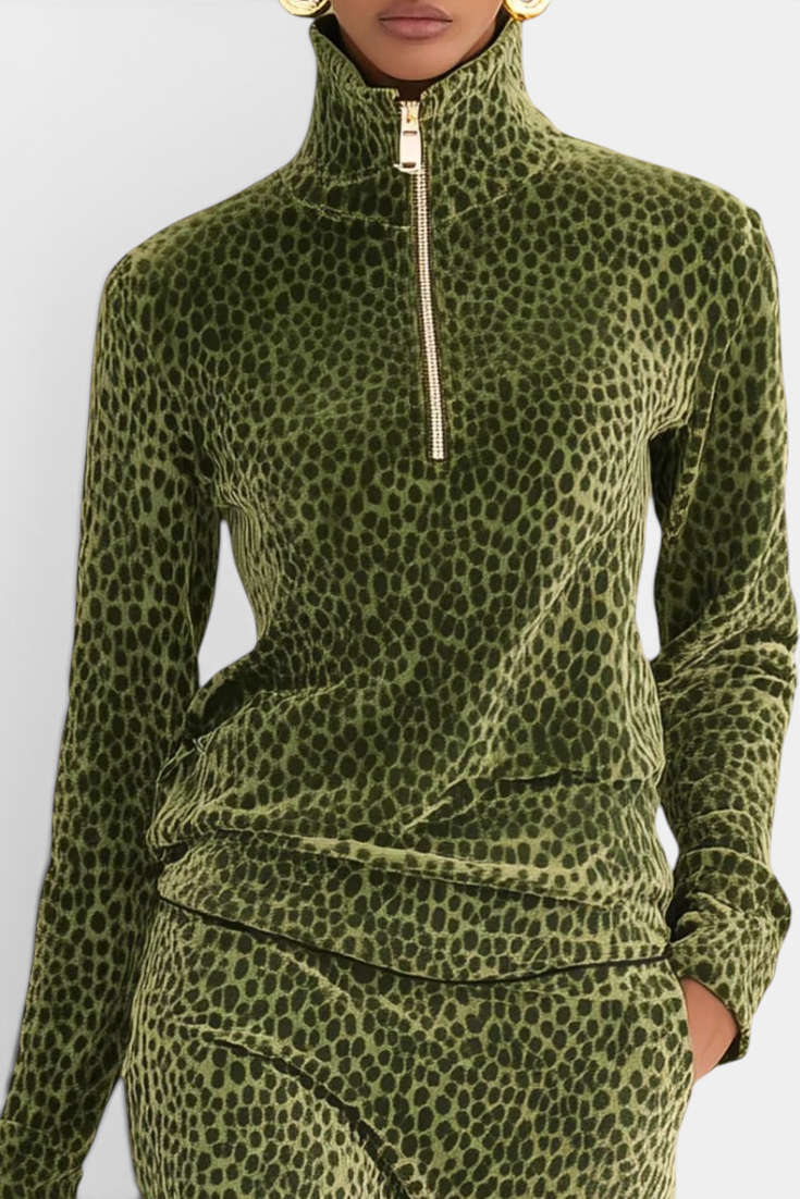 Mahaute Avdotya olive green velvet long-sleeve top with a high zip-up collar and animal print pattern.