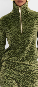 Mahaute Avdotya olive green velvet long-sleeve top with a high zip-up collar and animal print pattern.
