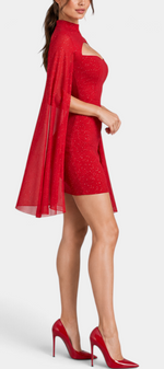 Mahaute Bea short red shimmering cocktail dress with high neck, chest cutout, and sheer cape sleeves on a model