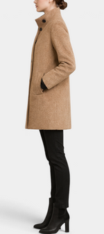 Mahaute Bellarya tan mid-length coat with a high collar, button front, and patch pockets worn by a model in profile.