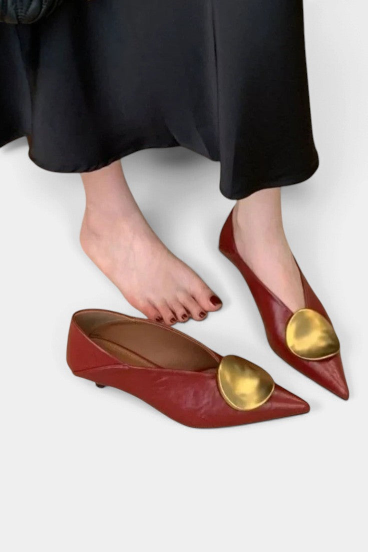 Mahaute Billini pointed toe kitten heel pumps in deep red leather with a large gold metallic ornament