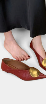 Mahaute Billini pointed toe kitten heel pumps in deep red leather with a large gold metallic ornament
