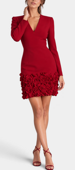 Mahaute Bilyana short red cocktail dress with long sleeves, V-neckline, and 3D floral applique hem on a model