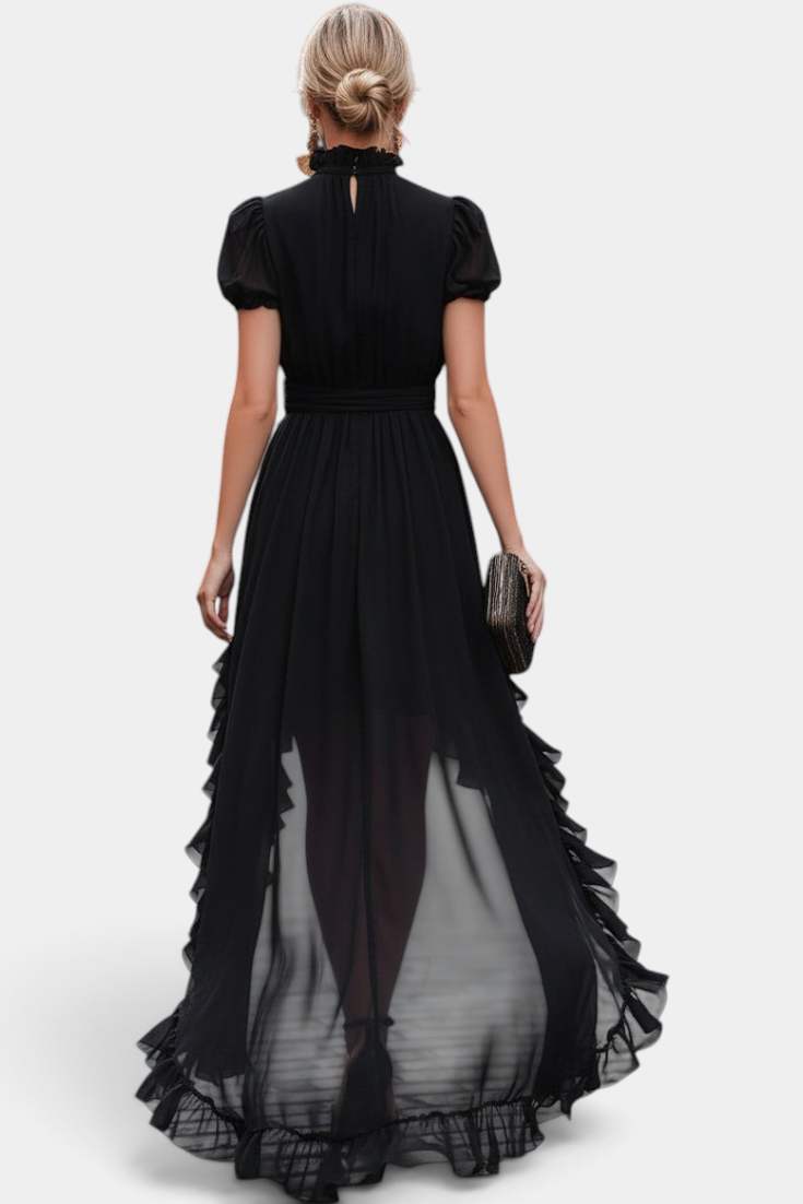 Back view of a woman wearing a Mahaute black asymmetrical long dress with ruffled hem and puffed sleeves