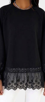 Mahaute black fluid blouse with 3/4 lace sleeves, floral lace hem, and ruffled cuffs for a feminine elegant look.