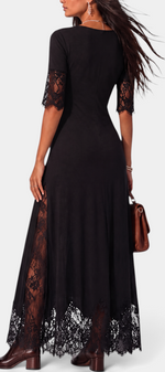 Mahaute black long dress with floral lace sleeves, side panels, and a scalloped lace hemline, back view.