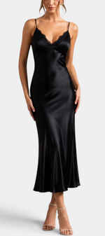Mahaute black satin long slip dress with lace-trimmed V-neck and thin spaghetti straps on a model