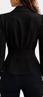 Back view of Mahaute black tailored blouse with cinched waist, long puff sleeves and gold button cuffs.