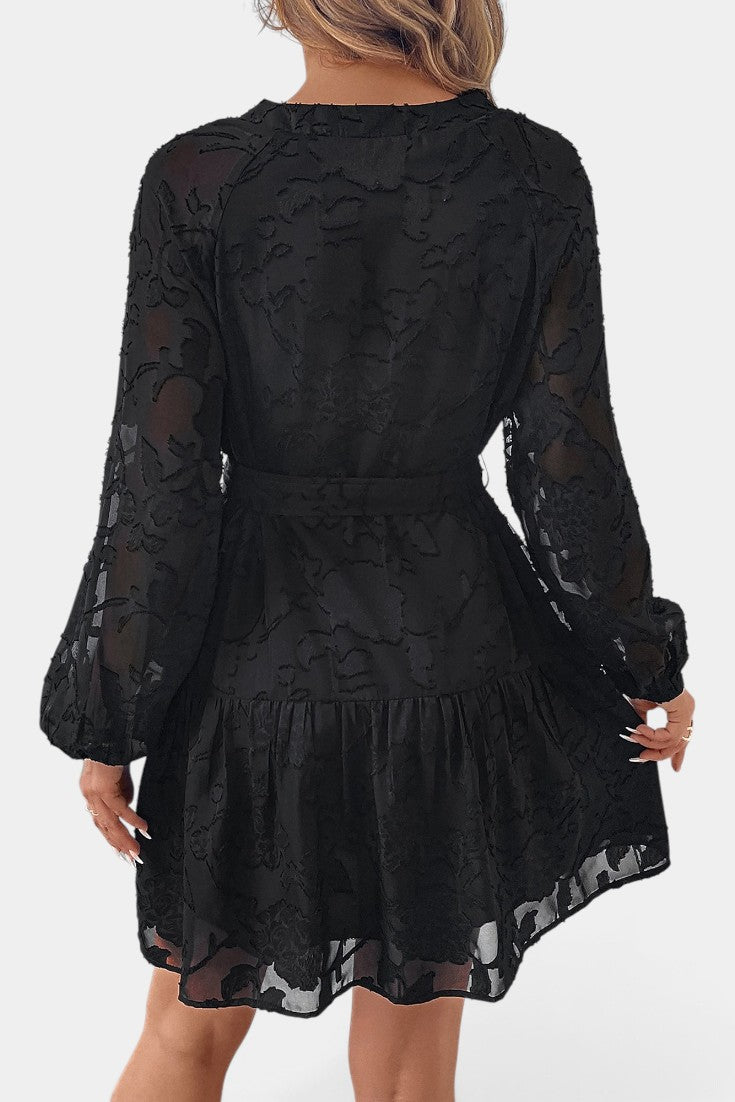 Robe courte Mahaute noire à motif floral texturé, ceinture et manches transparentes, élégante et moderne.