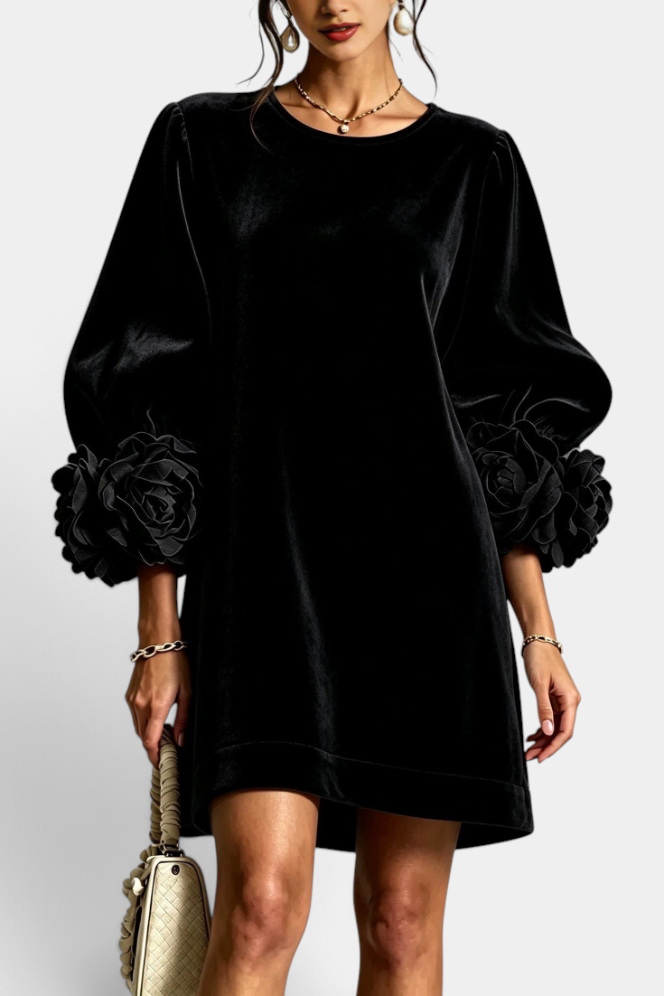 Mahaute Fuega black velvet short dress with voluminous puff sleeves and 3D floral details on the cuffs.