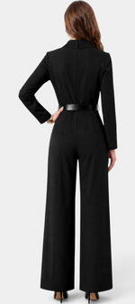 Back view of a Mahaute black long-sleeve jumpsuit with a collared neckline, belted waist, and wide-leg trousers.