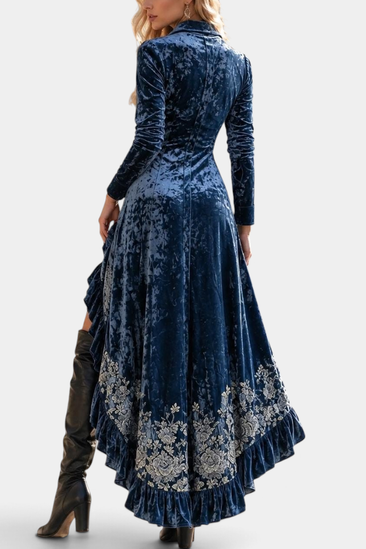 Mahaute long blue velvet dress with floral embroidery, asymmetric hem, and ruffles, worn with black leather boots.