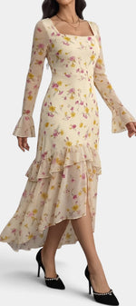 Robe longue Mahaute Brianda asymétrique à imprimé floral, encolure carrée et volants, portée élégante et féminine.