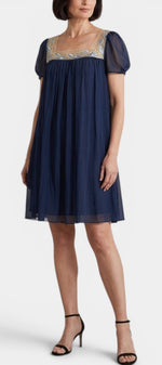 Mahaute Briony short navy blue dress with square neck, floral embroidery, and sheer butterfly sleeves.